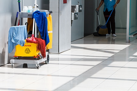 mop-bucket-on-cleaning-in-process-and-worker-background.jpg