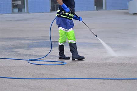 worker-in-high-visibility-work-clothes-washing-streets-with-water-jet.jpg